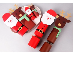 Macro view of festive Christmas cracker boxes with Santa and reindeer paper designs