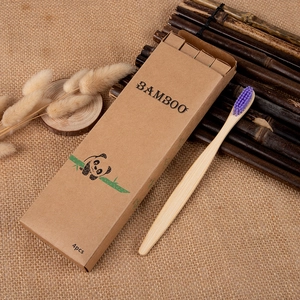 Eco-friendly bamboo toothbrush with purple nylon bristles in a natural craft paper box