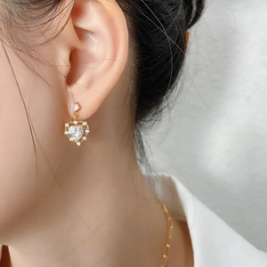Elegance 925 sterling silver heart studs with clear zircon crystals on model ear