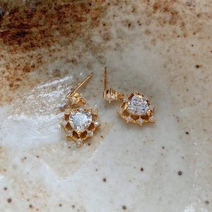 Close-up of heart-shaped 925 silver stud earrings with sparkling cubic zirconia stones