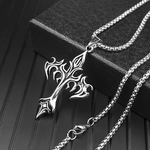 Mens stainless steel cross pendant necklace with box chain on dark textured display