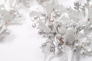 Close-up of silver glitter berries and frosted leaves for Christmas home decoration