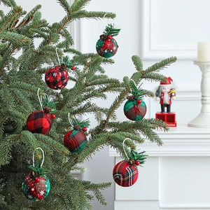 Plaid Christmas ball ornaments with pine cones and berries on a decorated holiday tree