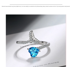 Macro detail of silver fishtail ring with blue heart zircon and pavé crystal accents