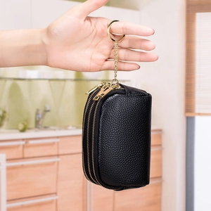 Black pebbled leather mini coin purse with double zippers and gold keychain hook