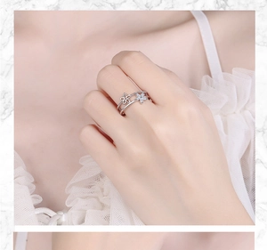 Detail of silver double-layer flower ring with sparkling stones worn by a model