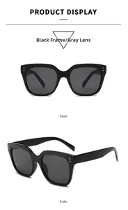 Detail view of large black frame sunglasses with double metal dot rivets and grey lenses