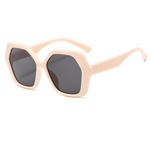 Modern oversized hexagonal sunglasses in nude beige with dark gray lenses for street style
