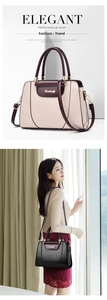 Detail of elegant two-tone tote bag with round handles and detachable shoulder strap