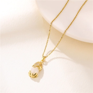 Detailed shot of golden Pixiu pendant with crystal inlay and white jade on O-chain