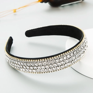 Cerchietto di cristallo scintillante con strass bianchi e base dorata su tessuto antiscivolo