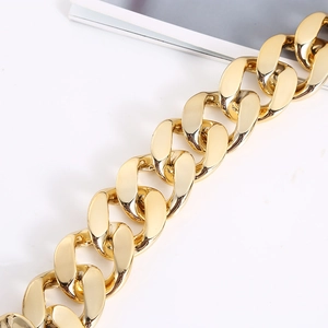 Close-up of a thick gold hip-hop Cuban link necklace with a polished metallic finish