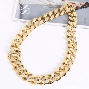 Flat lay of a heavy gold chunky cuban chain necklace with polished hip-hop style finish