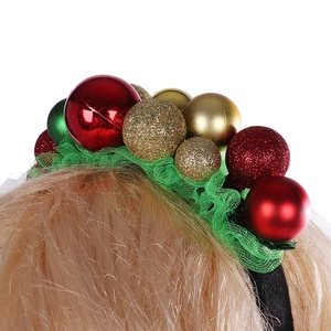 Close-up of a Christmas headband with colorful ornaments and green mesh on a white background