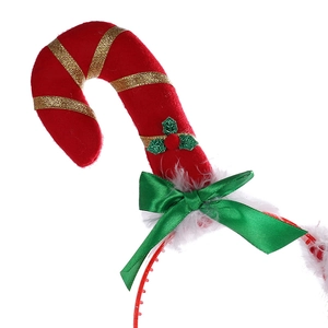 Detailed view of plush Christmas candy cane headband with green ribbon and holly berry decor