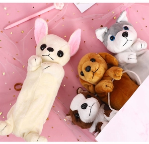 Flat lay of cute plush dog-shaped pencil cases in various breeds on pink desk