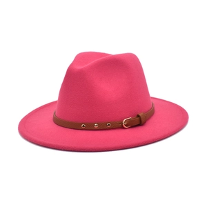 Detail of rose red wool fedora hat featuring a brown leather band with gold metal studs