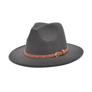 Detail of dark grey wool felt fedora with brown faux leather band and gold metal studs