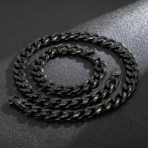 Detail of black Cuban link chain set with intricate baroque embossed floral clasp