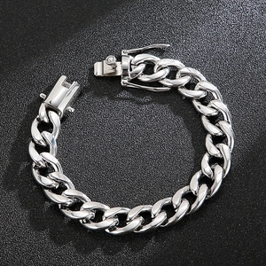 Detailed view of polished silver Cuban link bracelet with a secure box clasp closure
