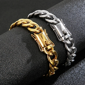 Macro view of gold and silver cuban link bracelets with sparkling cubic zirconia clasp