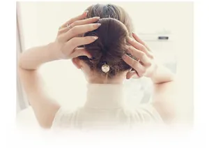 Detailed view of an elegant pearl hair tool for Korean-style buns on a female model