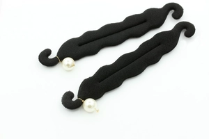 Detail of creative pearl hair bun maker with black velvet texture and golden wire