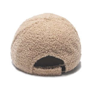 Detail view of the adjustable buckle and fuzzy sherpa texture on khaki baseball cap
