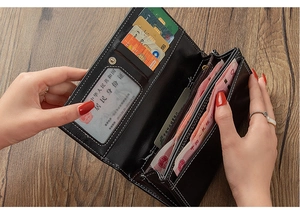 Close-up of black leather wallet interior featuring multiple card slots and clear ID window
