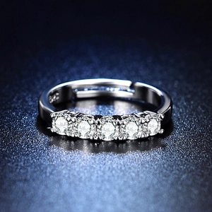 Macro shot of silver adjustable ring with five round sparkling cubic zirconia gems