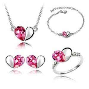 Silver jewelry set featuring pink heart crystals including necklace, bracelet, and ring