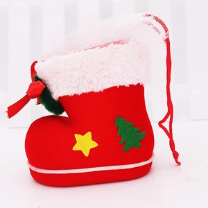 Detailed view of red flocked Christmas boot candy bag with plush white trim and green tree