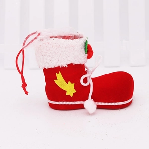Detail of red flocked Christmas boot candy bag with white plush trim and yellow star pattern