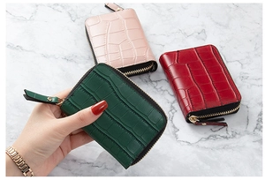 Detailed view of crocodile pattern PU leather card holders with smooth metal zippers