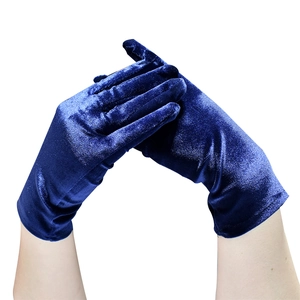 Close-up of deep blue velvet gloves for women with a luxurious silky texture and sheen