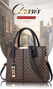 Close-up of retro printed handbag with gold metal hardware and sturdy top handles