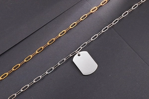 Detailed view of dual-layer stainless steel military dog tag necklaces in gold and silver