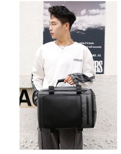 Detail of multi-functional business travel bag with waterproof compartments and top handle
