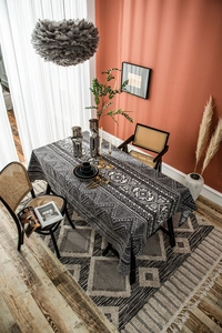 Top-down view of black and white geometric cotton linen tablecloth in a dining room