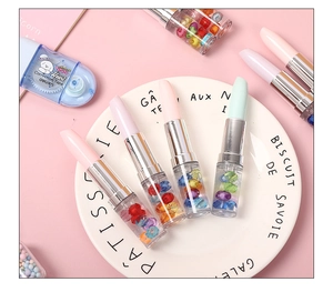 Detail of creative lipstick-shaped ballpoint pens with colorful floating beads inside