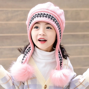 Pink knit hat for girls with ear flaps and large pom-poms for winter warmth