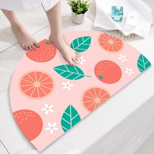 Semi-circular non-slip bath mat with fruit pattern on bathroom tile floor