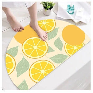 Detail of semi-circular lemon pattern bath mat in yellow and green showing water absorption