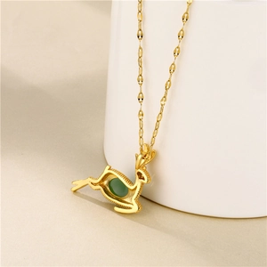 Elegant 18K gold elk necklace with green emerald pendant for women on a white tray