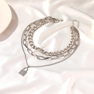 Three-layer silver chunky chain necklace featuring a rhinestone paved padlock pendant