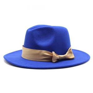 Detail view of royal blue wool fedora hat with elegant khaki ribbon and bow decoration