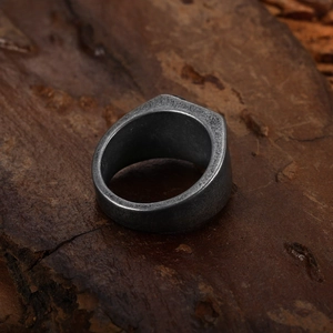 Vintage stainless steel anchor ring for men with distressed matte finish on wood block