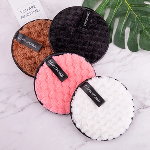 Reusable magic makeup remover pads in four colors on a minimalist marble surface