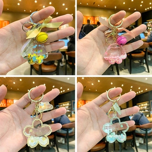 Close-up of sakura and cat paw glitter keychains in assorted colors with liquid sand