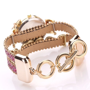 Detail of glitter watch strap with gold T-bar clasp and shiny metallic beads